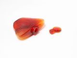 a picture of a piece of red glass with a red bead on it