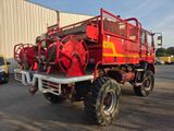 a large red fire truck parked in a parking lot