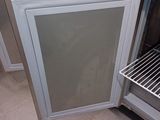a refrigerator with a door open in the middle of a kitchen