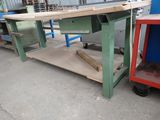 a workbench with a table on it in the middle of a warehouse