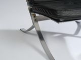 black leather lounge chair with chrome steel frame and foot rest
