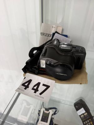 a camera and a cell phone on display in a glass case