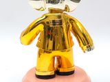 a gold statue of a man with a crown on his head
