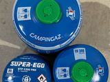 three propane gas cans sitting on top of each other on the ground