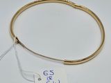 a close up of a gold bracelet with a price tag on it