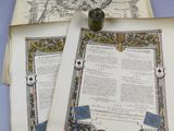 two pages of a book on a table with a pen and inkwell