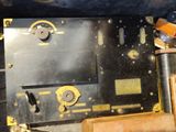 a close up of a machine with a clock on it ' s side