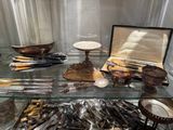 a glass display case filled with silverware and other items