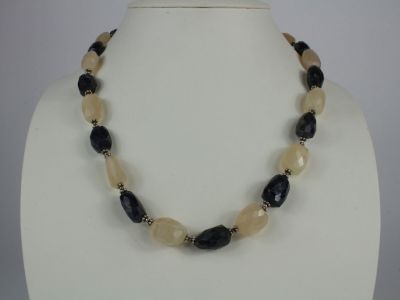 necklace with black and white beads on a white mannequin