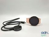 a close up of a smart watch with a cord attached to it