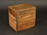 an old wooden box sitting on top of a black surface