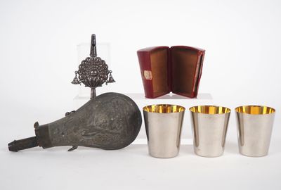 four cups and a bottle on the table