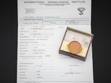 a certificate with a gold medal in a wooden box