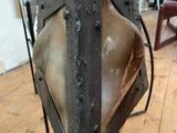 a large piece of metal on a stand in a room