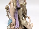 a figurine of a man and a woman with a dog