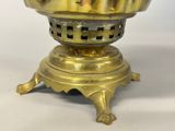 a gold colored candle holder on a white table
