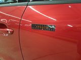 a red car that has a sticker on the door