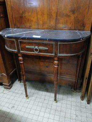 a small table with a marble top in a room