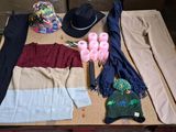a table with a hat, scarf, gloves, and other items on it