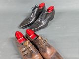 three pairs of men ' s shoes are lined up on a gray surface
