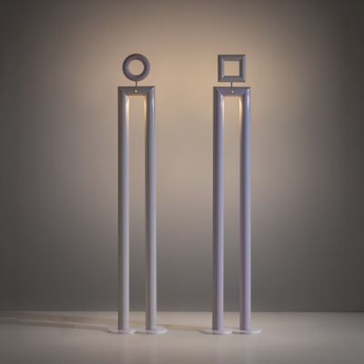 two tall metal poles with a light on top of them