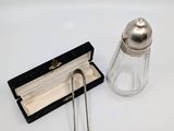 a salt and pepper shaker and a book on the table