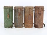 three old metal trash cans sitting next to each other on a white surface