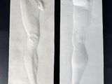 a pair of plaster sculptures of a man and a woman