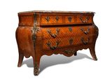 a small chest of drawers with a marble top