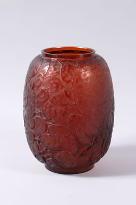 a red vase that is sitting on a white surface