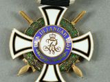 an image of a medal with a ribbon around it on a gray surface