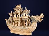 carved wooden model of a boat with a dragon on the front