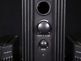 two speakers sitting next to each other on a black surface
