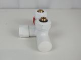 a white pipe with a red valve on a white table