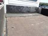 a white truck parked in a parking lot next to a building