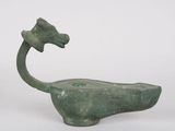 an image of a green statue of a horse with a long neck