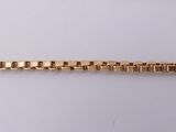 a gold bracelet with a chain that is attached to it