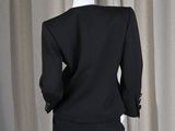 the back of a mannequin dress on display in front of a curtain