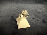 a close up of a gold ring on a black surface