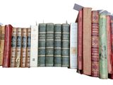many old books stacked on top of each other