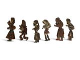many figurines of people walking together in a line