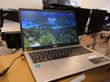 a laptop computer sitting on top of a box on a table