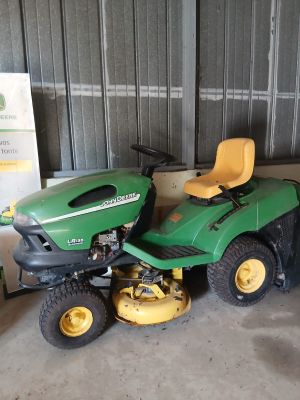 a picture of a lawn mower parked in a garage