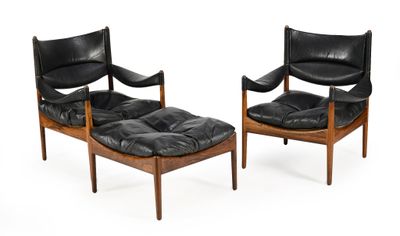 pair of black leather lounge chairs and ottoman with wooden legs