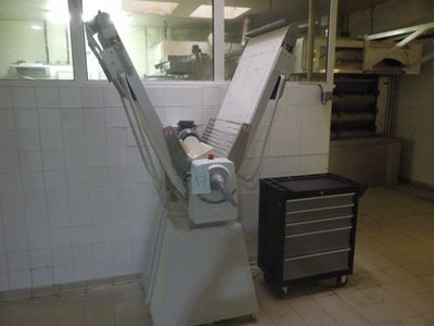 une machine qui se trouve dans une cuisine, à côté d'une poubelle