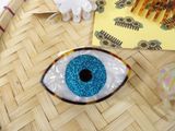 a picture of a blue eye broocher on a table