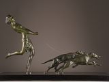 bronze statue of a man running with a dog on a leash