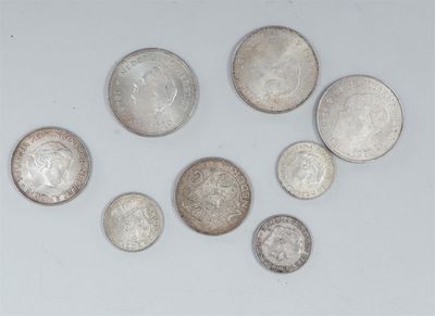 six different types of silver coins on a white surface