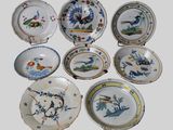 nine plates with different designs on them on a white surface