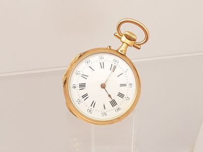 a gold pocket watch with roman numerals on it